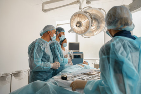 Concentrated surgical team working with a patient in an operation roomの写真素材