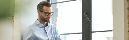 Attractive young manager working in the office alone