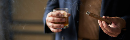 Close up shot of hand of mature man holding cigar and glass of w