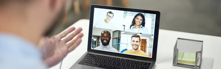 Boss conducting online meeting with his employeesの写真素材