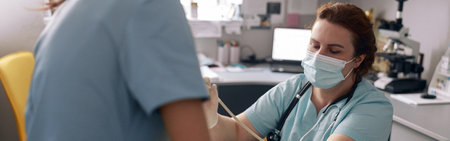 Skilled doctor performs ultrasound investigation while assistant holds animal in vet clinicの写真素材