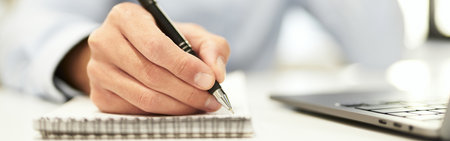 Listening to client and writing his requests into notebookの写真素材