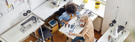 Team of mature lady and African-American woman dressmakers withの写真素材