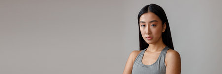 Asian woman with perfect skin standing in studioの写真素材