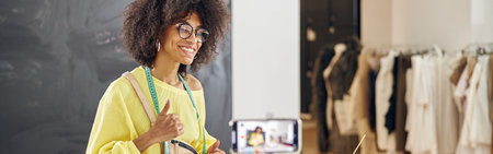 Professional African-American fashion designer with conducts online class at table with color palettesの写真素材