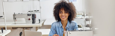 Smiling African-American lady fashion designer draws dresses modの写真素材