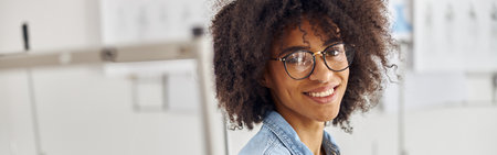 African-American seamstress with glasses and earring in nose holの写真素材