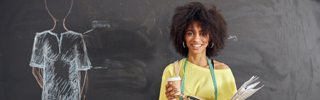 African-American woman teacher with tape measure, cup and papersの写真素材