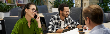 Young successful multiracial business team sitting at the desk and working together in the modern officeの写真素材
