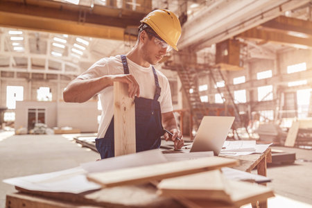 Handsome man builder using notebook at construction siteの写真素材