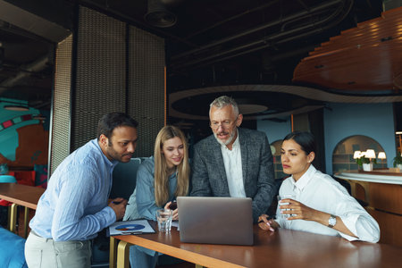 Group of people discussing daily plans in the office using laptop. Business teamwork situationの写真素材
