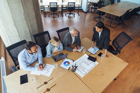 Team of business investors is discussing a new project in modern office. Concept of financingの写真素材