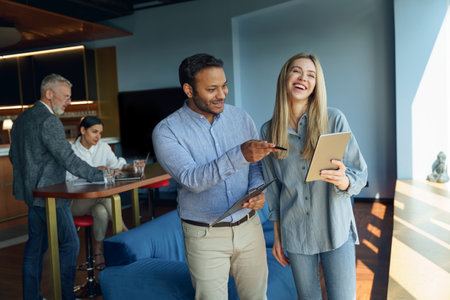 Group of diverse business people standing on office background and discuss work issuesの写真素材