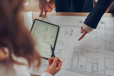 Close up of professional team design engineers working with project documents in modern office