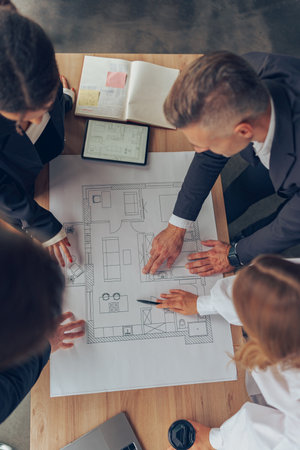 Group of professional team design engineers working with project documents in modern officeの写真素材