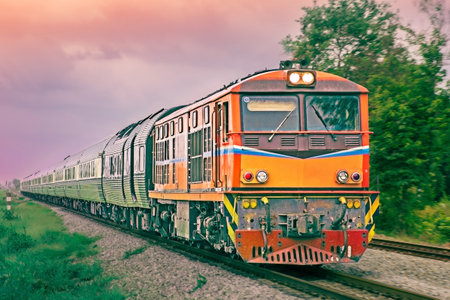 Passenger train by diesel locomotive on the railway.の写真素材
