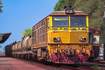 Tanker-freight train by diesel locomotive on the railway.