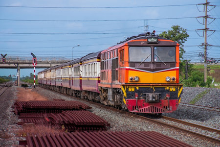 The train moves along the railway tracks. Locomotive on a background of blue sky.の写真素材