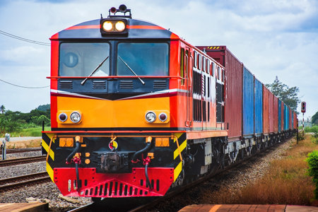 Locomotive with cargo containers in the railway station, Thailand.の写真素材