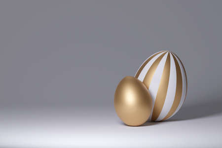 Golden eggs on a gray background. 3d renderの写真素材
