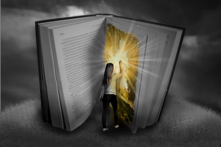 Photo montage of young girl going to fairytale bookの写真素材