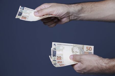 Handling fifty reais notes, Brazilian money notesの写真素材