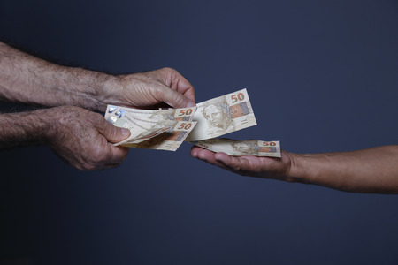 Handling fifty reais notes, Brazilian money notesの写真素材
