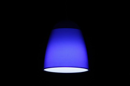 Blue circular lamp on black background