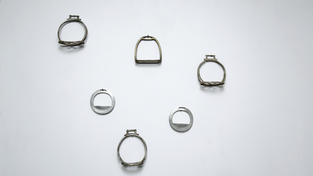 Several metal stirrups fixed to white wallの写真素材