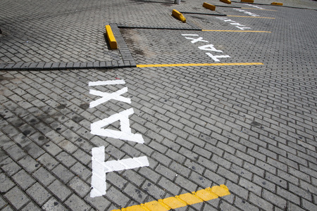 Taxi sign posted in public way with white paintの写真素材