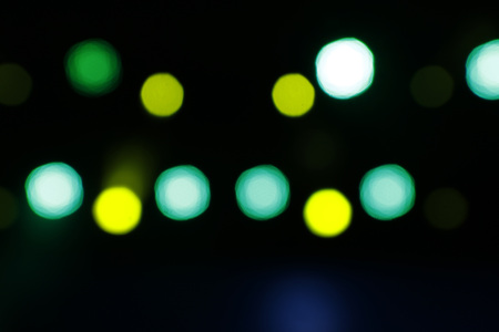Blurred lights yellow and green with dark scenary - Defocused image - Background concept with light points yellow and green - Blurry bokehの写真素材