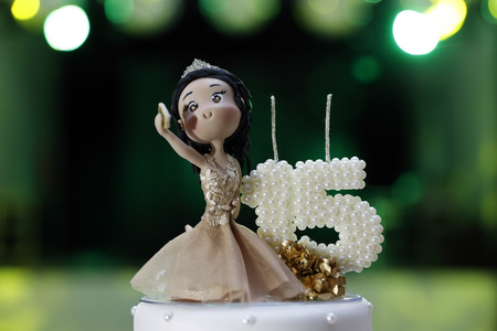 Party cake, 15 year anniversary, with doll holding cell phoneの写真素材