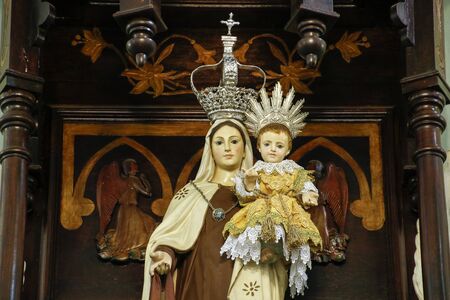 Statue of the image of Our Lady of Carmel, Nossa Senhora do Carmo, mother of God in the Catholic religion, decorated with flowersの写真素材