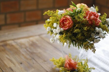 Floral arrangement on wood table, wood textured surface, neutral space, wood textured flower arrangementの写真素材