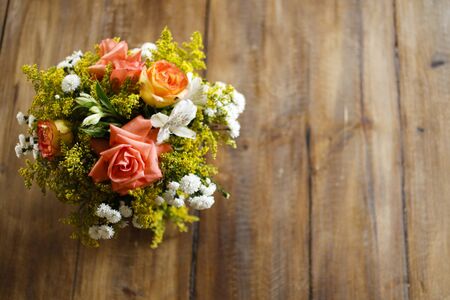 Floral arrangement on wood table, wood textured surface, neutral space, wood textured flower arrangementの写真素材