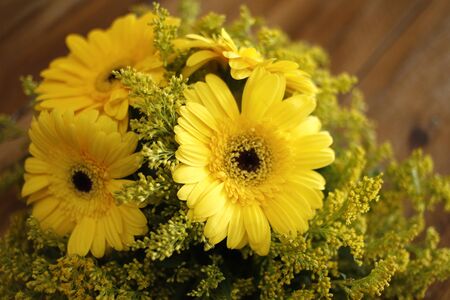 Floral arrangement on wood table, wood textured surface, neutral space, wood textured flower arrangementの写真素材