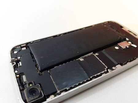 swollen mobile phone battery. phone Battery Replacement. old damaged battery smartphone.