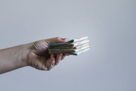 Hands holding Brazilian real notes, money from Brazil, notes of Real, Brazil BRL banknote, Brazilian currency, economy and business.の写真素材