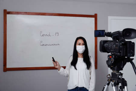 Oliveira, MG / Brazil - 2020-04-08: Teacher with respiratory protection mask during presentation of online virtual classのeditorial素材