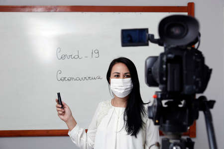 Oliveira, MG / Brazil - 2020-04-08: Teacher with respiratory protection mask during presentation of online virtual classのeditorial素材