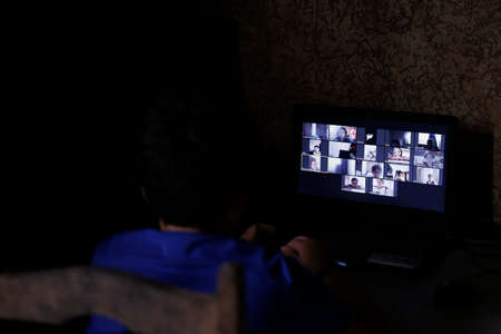 Oliveira, MG / Brazil - 2020-04-22: student participates in online classroom at home on computer