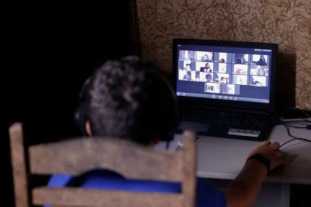 Oliveira, MG / Brazil - 2020-04-22: student participates in online classroom at home on computer