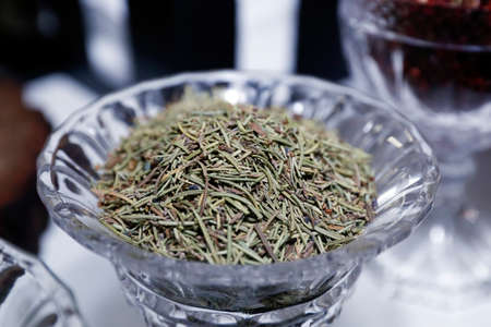green branches of rosemary Rosmarinus officinalis in glass potの写真素材