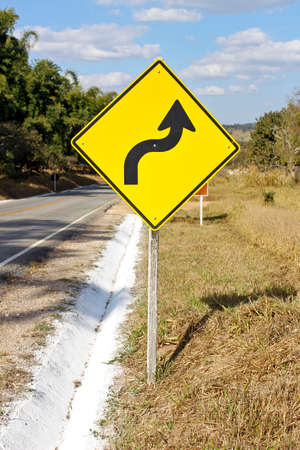 warning traffic sign - sharp right curve - S curveの写真素材