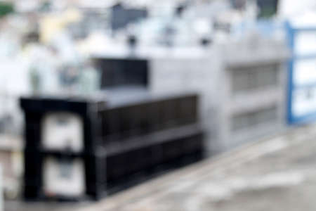 blurred indoor scene of a cemetery showing several serious