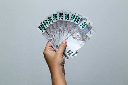 Hands holding Brazilian real notes, Brazil BRL banknote, Brazilian currency, economy and business.の写真素材