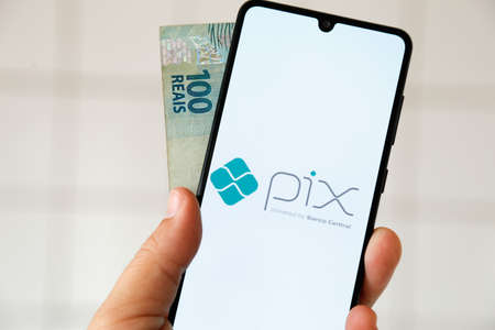 Minas Gerais, Brazil - April 29, 2021: cell phone screen with pix central bank of brazil instant payment systemのeditorial素材