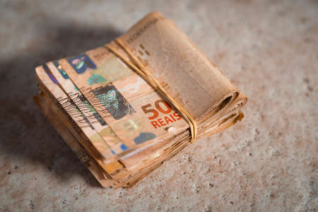 Brazil money stacked and grouped - several Brazilian real banknotes in rubber bandの写真素材