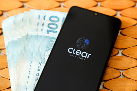 Minas Gerais, Brazil - April 19, 2021: smartphone cell phone screen with Clear broker brand and...