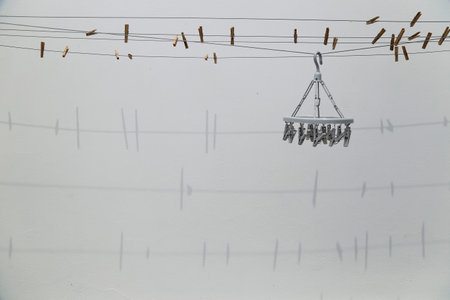 shadow on the wall of clothesline and clothespinsの写真素材